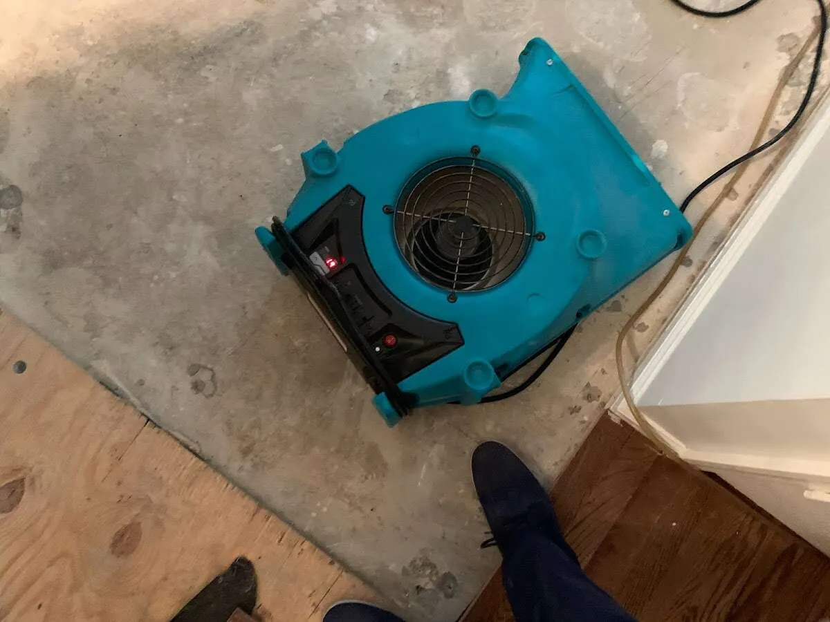 Air mover drying subfloor during Leak Detection & Repair in Crooked River Ranch